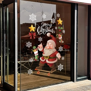 Christmas window decals featuring Santa on a skateboard with snowflakes and stars on glass door