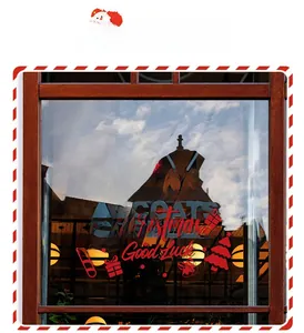 Close-up of red Merry Christmas window stickers with festive stars and snowflakes