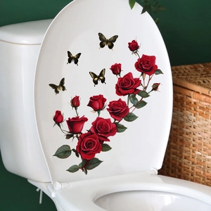 Detail of red rose and gold butterfly waterproof wall stickers on a white toilet lid