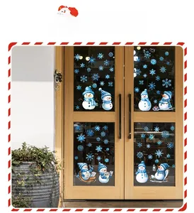 Detailed view of Christmas snowman and blue snowflake static window decals on glass doors