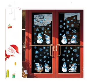 Detailed view of blue snowman and snowflake static stickers on a red glass door