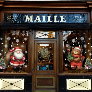 Christmas window decals with Santa Claus, teddy bear, and tree on a glass shop front