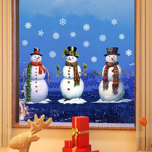 Detail view of static Christmas window stickers featuring snowmen and snowflakes on glass