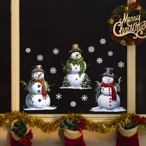 Detail of Christmas snowman window clings with snowflakes on a festive dark glass background