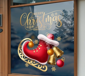 Detail view of Merry Christmas window sticker with red stocking and golden bells on glass