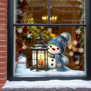 Detail of Christmas window sticker featuring a snowman with blue hat and white snowflakes