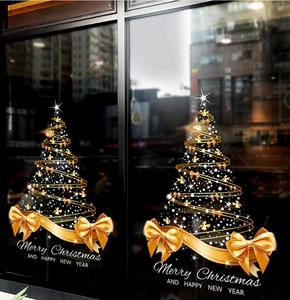Detail of golden spiral Christmas tree window static sticker with a large gold ribbon bow