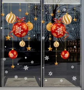 Close-up of festive Christmas ball and snowflake static glass stickers on a window