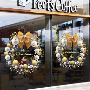 Luxurious Christmas window stickers with gold reindeer and bows on a glass cafe door