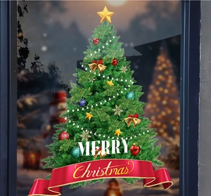Detail of decorated green Christmas tree window sticker with Merry Christmas ribbon