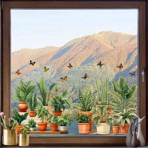 Close-up of green potted plant and butterfly static stickers on glass window