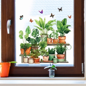 Detail of green potted plant and butterfly static window clings on glass window pane
