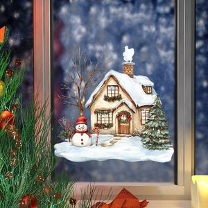 Macro detail of Christmas window static cling showing watercolor snow house and snowman