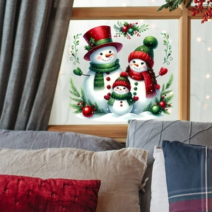 Detailed view of Christmas snowman window stickers on a wooden glass pane for home decor