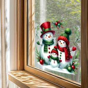 Detailed view of Christmas snowman family window stickers with festive pine and berry accents