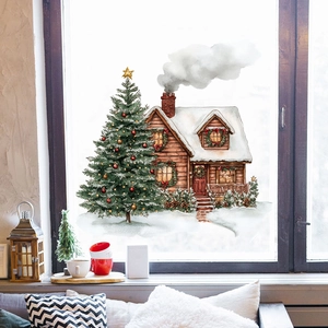 Cozy scene of watercolor Christmas tree and snow cabin stickers on a glass window