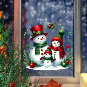 Detailed view of snowman family static window stickers on a snowy winter background