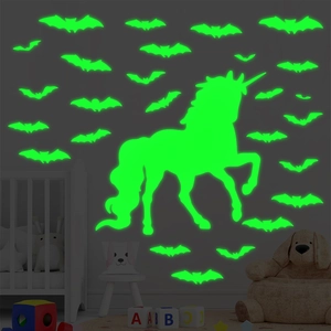 Luminous unicorn and bat wall stickers glowing in a dark nursery room setting