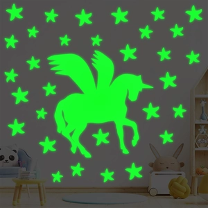 Luminous unicorn and stars wall stickers set glowing in a dark themed children bedroom