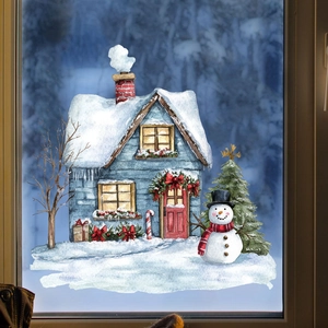 Close-up of static Christmas window cling featuring a cozy snow cabin and a snowman