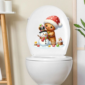 Détail d'un autocollant de Noël avec bonhomme de neige et pain d'épice sur un couvercle WC