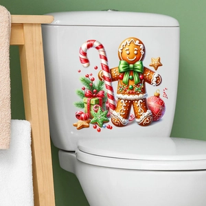 Close-up of festive gingerbread man and candy cane holiday stickers on a white surface