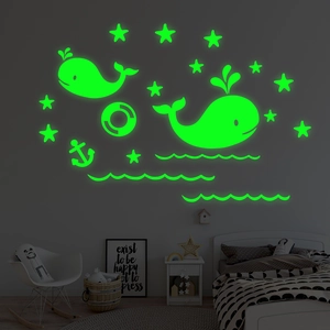 Glow-in-the-dark ocean wall decals featuring luminous whales and stars in a child's bedroom