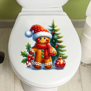 Close-up of festive Christmas gingerbread man and tree sticker on a white toilet lid