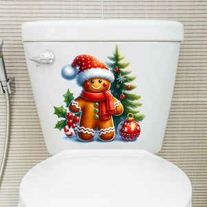Detailed view of gingerbread man and Christmas tree stickers on white toilet tank