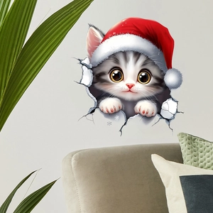 3D wall sticker featuring a cute grey kitten in a red Santa hat breaking through a grey wall