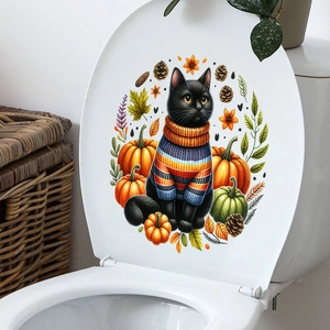 Close-up of autumn cat sticker with maple leaves and pumpkins on a white toilet lid