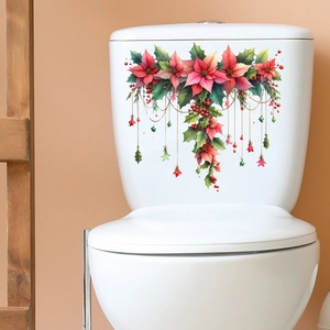 Dettaglio di adesivi natalizi con stelle di Natale su superficie in ceramica bianca