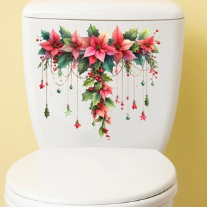 Dettaglio degli adesivi natalizi con poinsettia rossa e foglie verdi su ceramica bianca