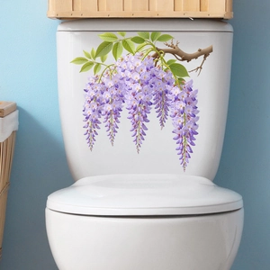 Detailed view of realistic purple wisteria flower stickers applied to a white toilet tank