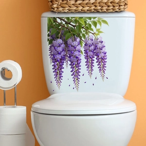 Macro detail of waterproof wisteria flower stickers applied on a white ceramic toilet