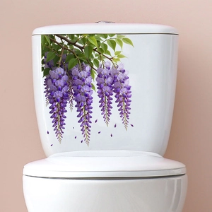 Detail of purple wisteria flower stickers on a white ceramic toilet tank surface