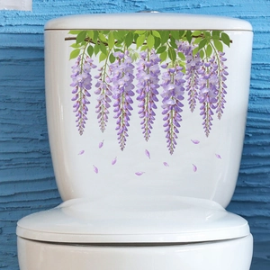 Detail of purple wisteria floral stickers on a white toilet tank for bathroom decor