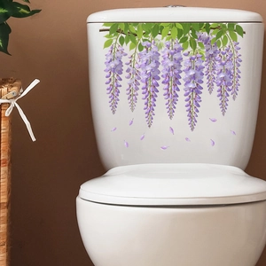 Detailed view of wisteria flower wall sticker applied on a white ceramic toilet tank surface