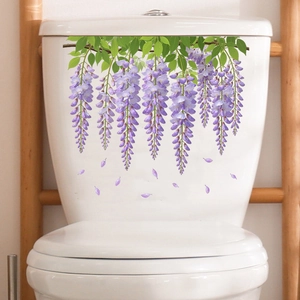 Detail of waterproof wisteria flower stickers applied on a white ceramic toilet tank