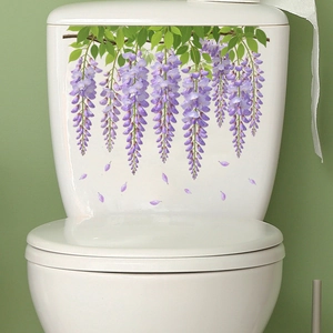 Detail of purple wisteria flower wall stickers applied on white ceramic toilet tank surface