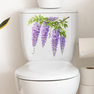 Detail of purple wisteria flower wall decals applied on a white ceramic toilet tank