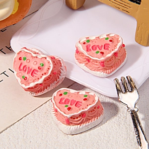 Close-up of miniature resin heart cakes with LOVE text for DIY crafts and decor