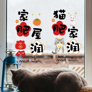 Close-up of New Year window clings with lucky cats and red lanterns on glass