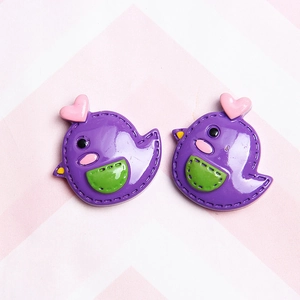 Detail of purple cartoon resin bird charms with pink hearts for DIY hair accessories