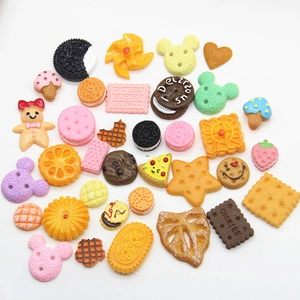 Flat lay of colorful resin cookie and cake miniatures for DIY phone case crafts