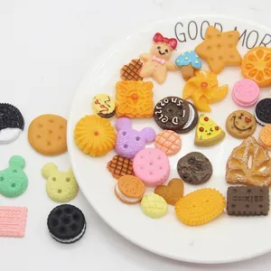 Mix of colorful resin cookie charms including Oreo, gingerbread man, and macaron shapes