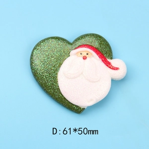 Detail of a 61x50mm heart-shaped resin Santa Claus charm with green glitter finish