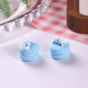 Macro shot of sky blue clay macaron accessory with blue and white striped bow