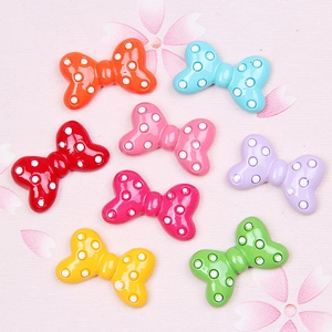 Close-up of assorted resin polka dot bows in vibrant colors for DIY hair accessories