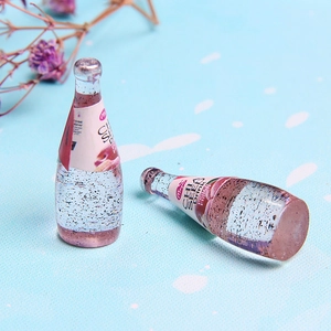 Macro detail of miniature peach chia seed drink bottles made of transparent resin